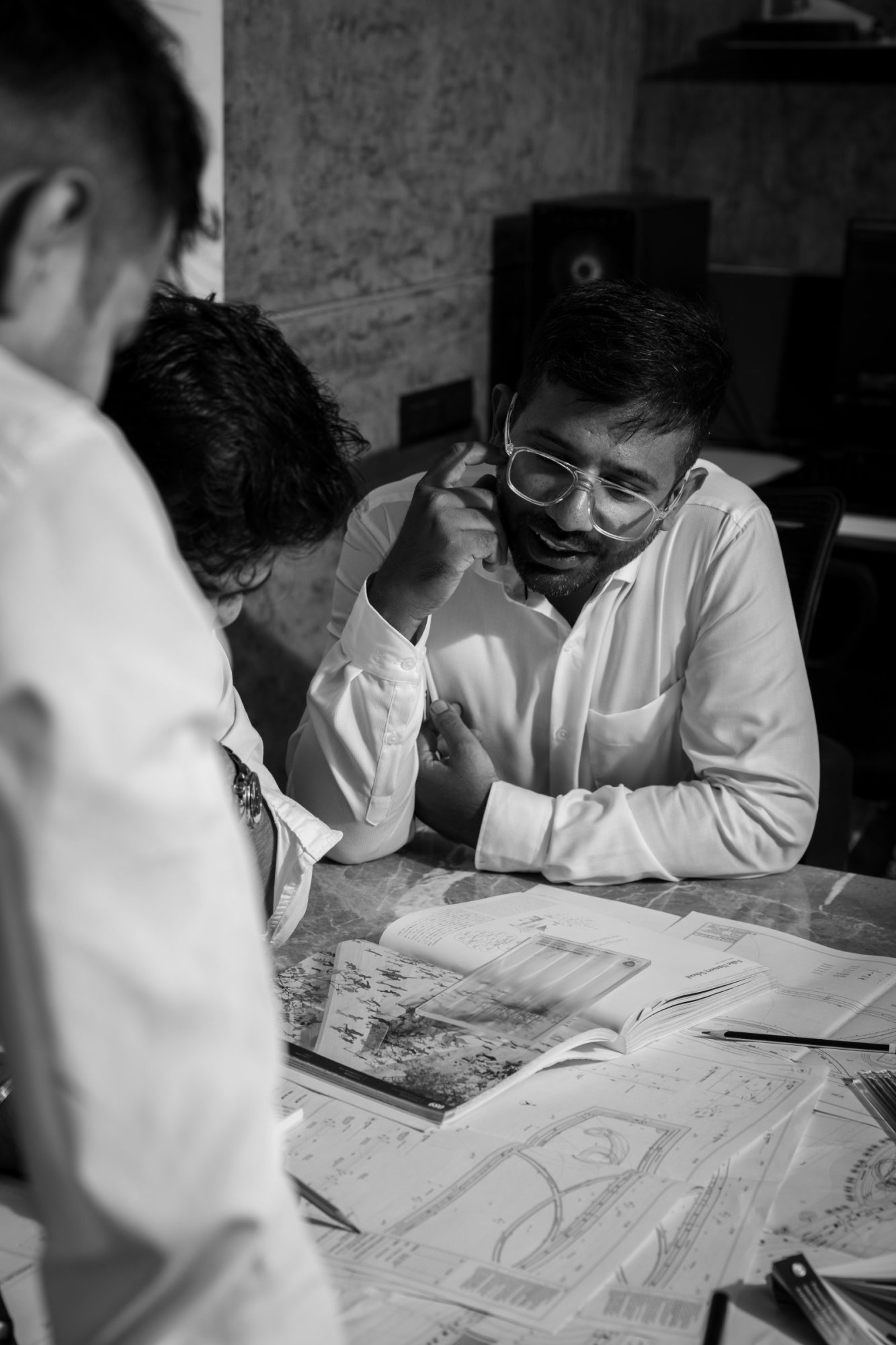 Mustafa Lokhandwala reviewing drawings with a colleague
